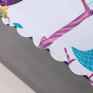 Close-up of wavy embroidered edges and colorful floral pattern on linen microwave cover