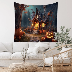 Detail of Halloween tapestry featuring glowing pumpkins and spooky cabin over a white sofa