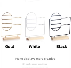 Detailed view of wood and metal jewelry stands for earrings and necklaces in three finishes