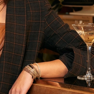 Detail of 18K gold stainless steel multi-layer tennis bracelet with white zircon and black beads