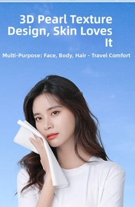 Detail showing the 3D pearl texture of a disposable cotton face towel for travel