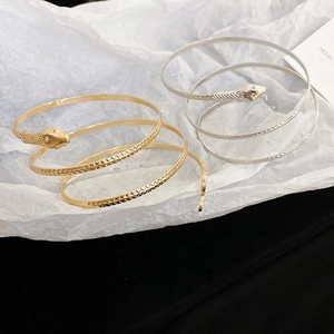 Elegant snake-shaped wrap bracelet in gold and silver finish with detailed scale texture