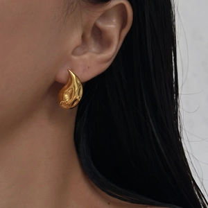 Modern gold teardrop earrings with a textured molten liquid finish for women