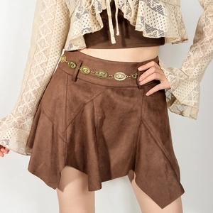 Detail of vintage gold metal waist chain with textured oval discs on brown suede skirt