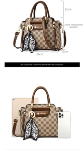 Detail view of brown checkered handbag size comparison with iPad and silk scarf accent