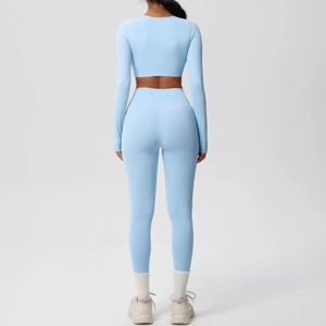 Light blue yoga set featuring a long sleeve crop top and high waist leggings in a back view
