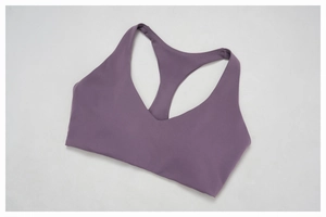 Detail of V-neck sports bra in ash purple stretch fabric with racerback design