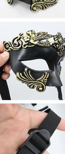 Detailed view of Venetian gladiator half face mask featuring gold and black split finish