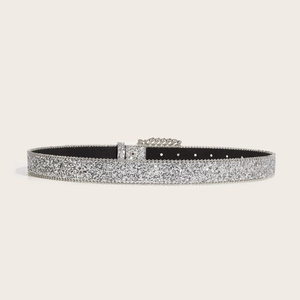 Sparkling silver rhinestone belt with square buckle and sequin finish on beige background