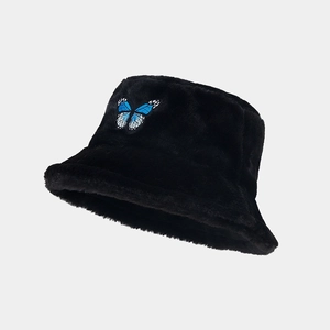 Detail of blue butterfly embroidery on black plush winter faux fur bucket hat