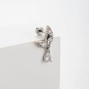 Silver leaf-shaped earrings with clear zircons and water drop pendant on a white stand