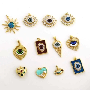 Detail of 18k gold plated evil eye charms with colorful enamel and zircon inlays