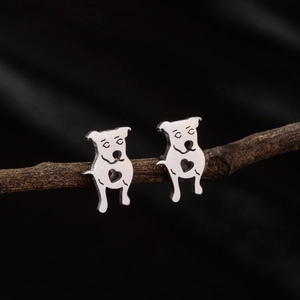 Macro shot of silver stainless steel puppy stud earrings with hollow heart details