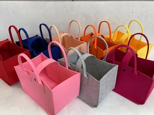 Colorful felt tote bags in various colors showing reinforced stitching and material texture