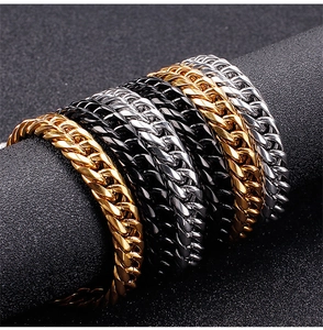 Macro shot of Cuban link bracelets in gold black and silver finishes on a display