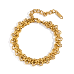 Macro shot of double-layered golden stainless steel chain bracelet with S.STEEL tag