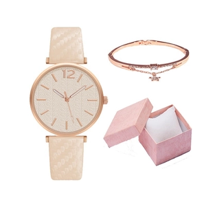 Close-up of beige quartz watch with rose gold bracelet in pink gift box set