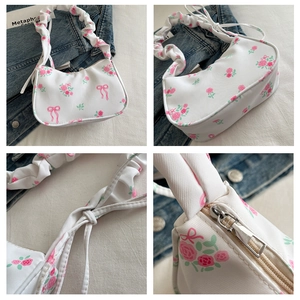 Close-up of canvas bag featuring pink rose print, ribbon bow and pleated shoulder strap