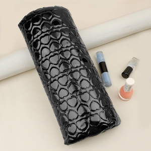 Detail of black glossy PU leather nail arm rest with embossed heart pattern texture