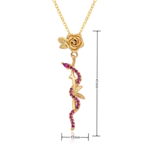 Detailed close-up of a gold-plated snake and rose pendant with micro-set purple stones