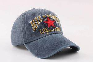 Detail of washed blue cotton baseball cap featuring HILARITY embroidery and red star