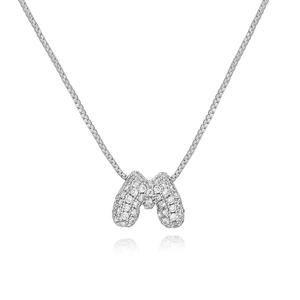 Close-up of a silver-toned bubble letter M pendant necklace with sparkling zircon pavé
