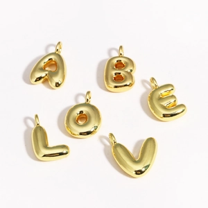 Detail view of 3D bubble style alphabet pendants A B E L O V in polished gold finish