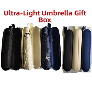 Three ultra-light folding umbrellas in black, cream, and navy with matching hard-shell cases