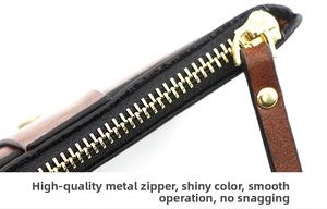 Macro view of a smooth gold metal zipper on a premium brown leather card holder wallet