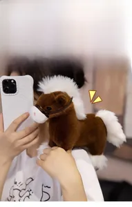 Close-up of a cute brown plush pony accessory held in hand to show its soft texture