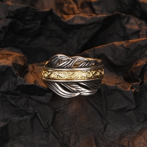 Three-layer feather ring in gold and silver contrast metal with sparkling gemstones