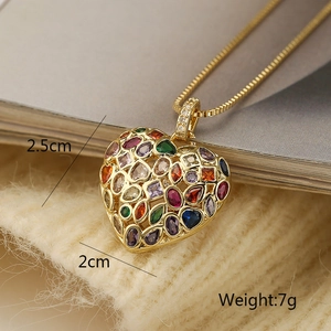 Detailed view of gold heart pendant with colorful stones and dimensions 2.5cm x 2cm