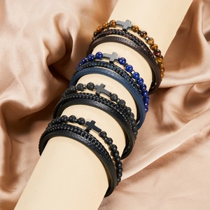 Detail of multi-layer leather bracelets with natural stone beads and metal cross pendant