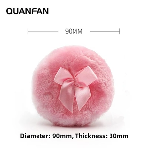Detail view of pink plush powder puff with bow, 90mm diameter and 30mm thickness specs