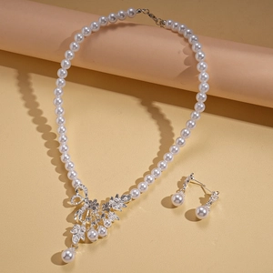 Elegant silver necklace and earring set with pearls and leaf pattern crystals