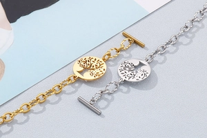 Detailed close-up of tree of life charm bracelets in gold and silver with OT clasp