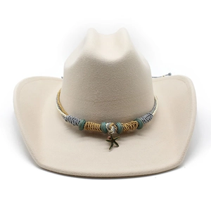 Detail of beige felt cowboy hat featuring woven band with starfish pendant and beads