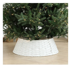 Detailed view of white hand-woven Christmas tree fence collar on warm indoor wood floor