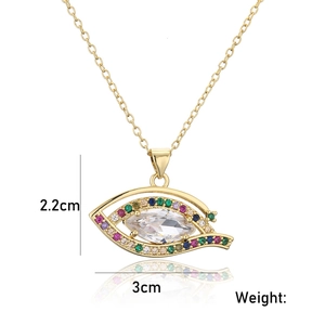 Macro detail of gold devil's eye pendant with colorful zircons measuring 30mm by 22mm