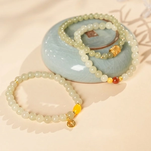 Green Hetian jade style beaded bracelet set with gold Fu pendant and amber accents