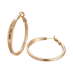 Polished gold round hoop earrings with CELINN engraving on white background