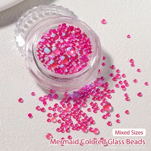 Macro detail of mixed size aurora mermaid bubble glass beads in vibrant pink for nail art