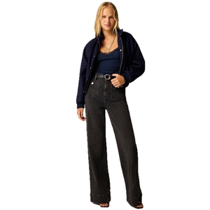 High-waist wide-leg denim jeans styled with a dark blue jacket and black leather belt
