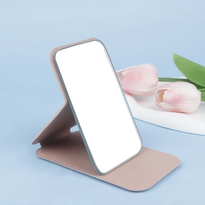 Close-up of pink PU leather folding makeup mirror with stable triangular support design