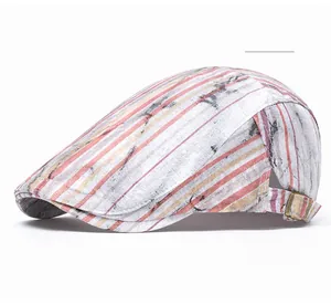 Detailed view of the vintage distressed striped beret with adjustable bronze buckle