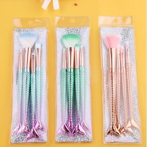 Detailed view of four-piece mermaid makeup brush sets with vibrant gradient fishtail handles