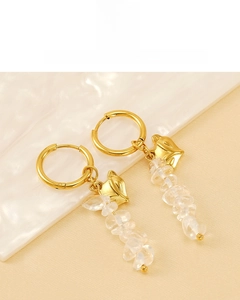 Detail of 18K gold plated fox head earrings with natural crystal stones on white background