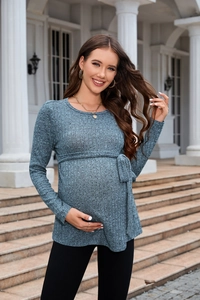 Detail of blue-grey maternity knit sweater featuring rib texture and adjustable waist tie