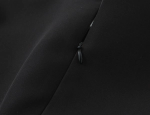 Close-up of the invisible zipper and stitching on the black polka dot dress