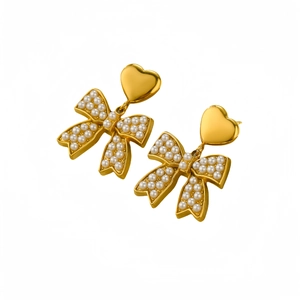 Elegant gold bow earrings with heart charm and inlaid pearls on a clean white background